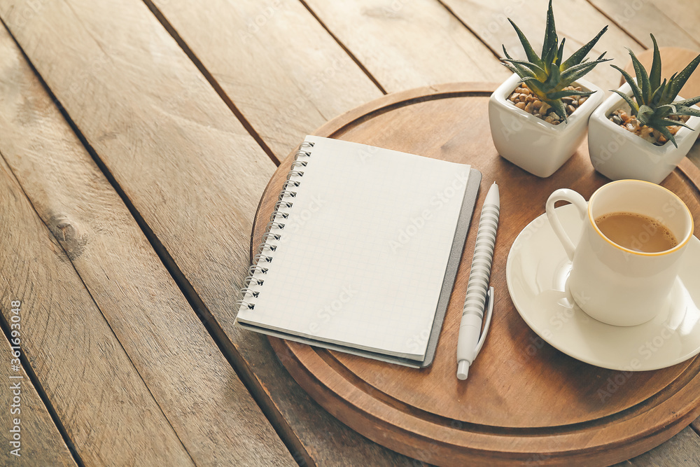 Composition with notebook and cup of coffee on wooden background Composition with notebook and cup of coffee on wooden background
