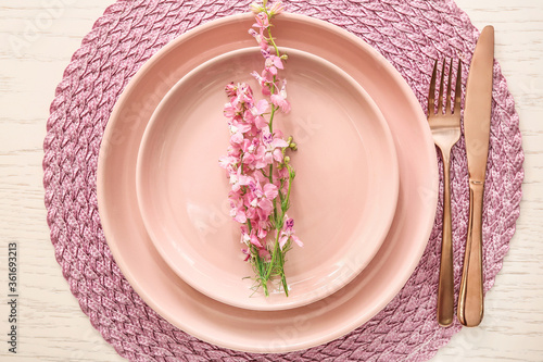 Simple table setting on white wooden background