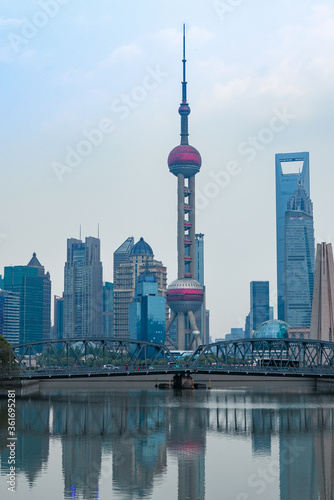 Sunset view of Waibaidu Bridge and Lujiazui  the skyline and landmark in Shanghai  China  with reflection in front.