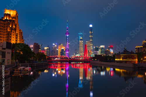 Night view of Waibaidu Bridge and Lujiazui  the skyline and landmark in Shanghai  China  with reflection in front.