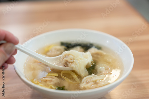 Wonton soup, Chinese traditional food with boiled meat filled wonton and seaweed soup.