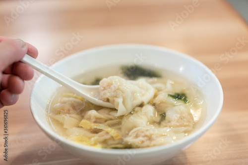 Wonton soup, Chinese traditional food with boiled meat filled wonton and seaweed soup.