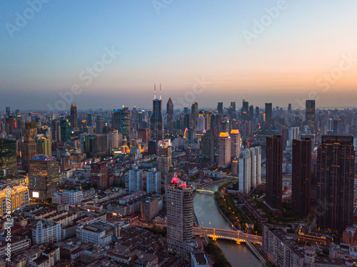 The skyline of skyscrapers along the Suzhou River, in Shanghai, China, at sunset.
