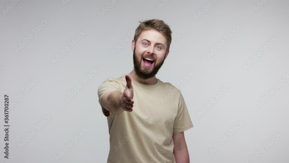 Hello, nice to meet you! Amiable happy bearded man welcoming, giving congrats with outstretched hand offering handshake, greeting with toothy smile, acquaintance concept. indoor studio shot isolated Hello, nice to meet you! Amiable happy bearded man welcoming, giving congrats with outstretched hand offering handshake, greeting with toothy smile, acquaintance concept. indoor studio shot isolated