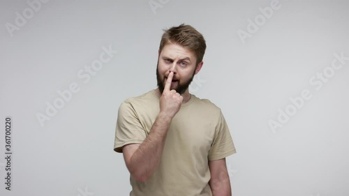 You lie to me! Bearded man suspecting falsehood, touching nose doing liar gesture and pointing at camera, angry about deception, distrustful communication. studio shot isolated on gray background