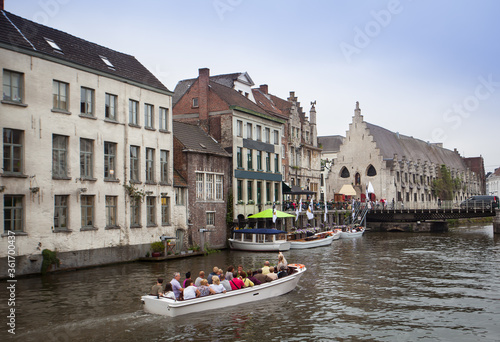 Sightseeing boat on Ghent canal and building architecture and landmark of Ghent Belgium