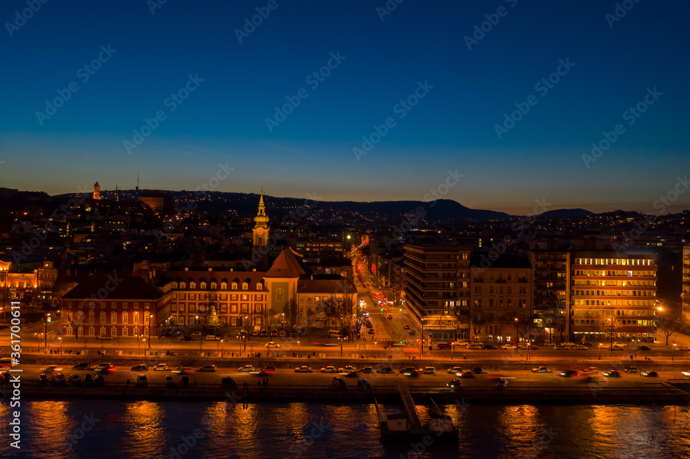Aerial drone shot of St. Francis parish church by Danube in Budapest twilight