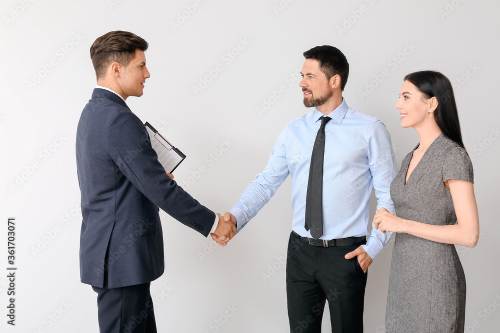 Business people shaking hands on light background Business people shaking hands on light background