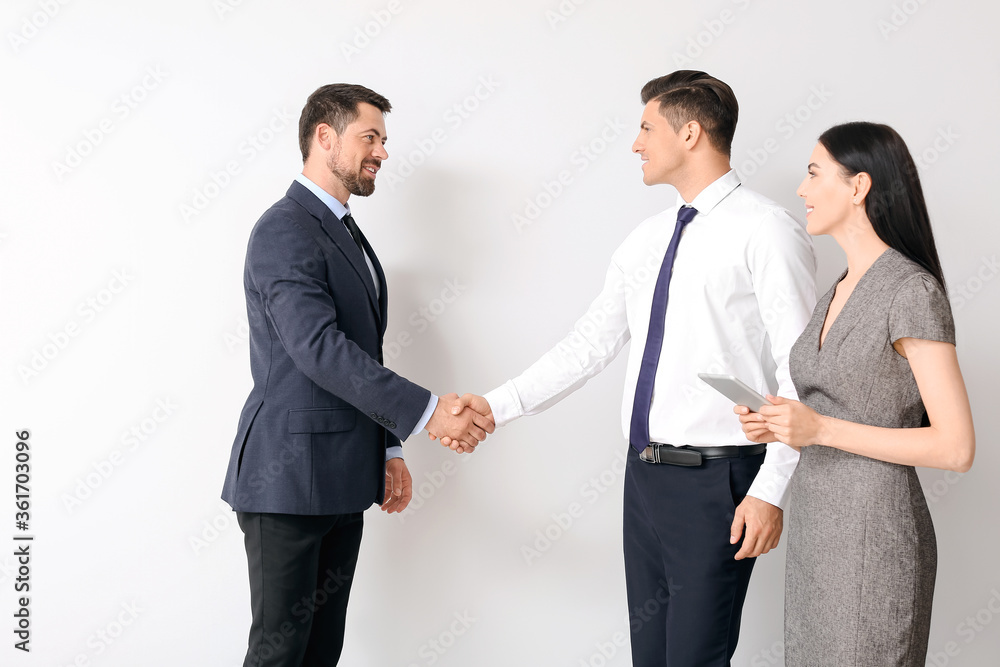 Business people shaking hands on light background Business people shaking hands on light background