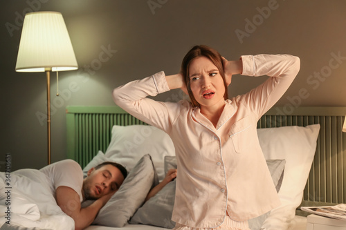 Young irritated woman in be...