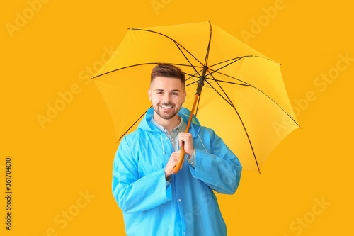 Young man in raincoat and w...