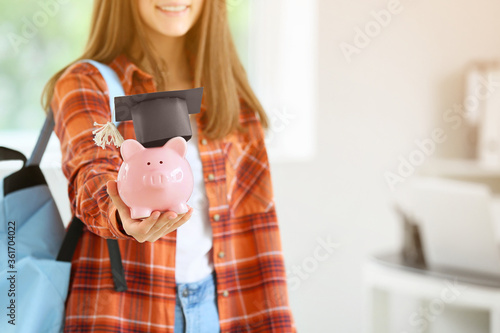 Teenage girl with savings for education in classroom