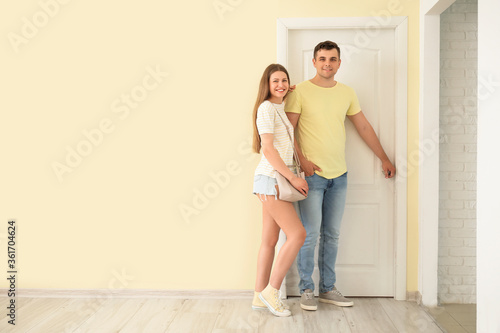 Happy couple in front of door at their new home © Pixel-Shot