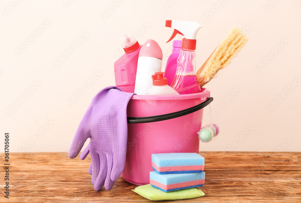Bucket with set of cleaning supplies on table Bucket with set of cleaning supplies on table