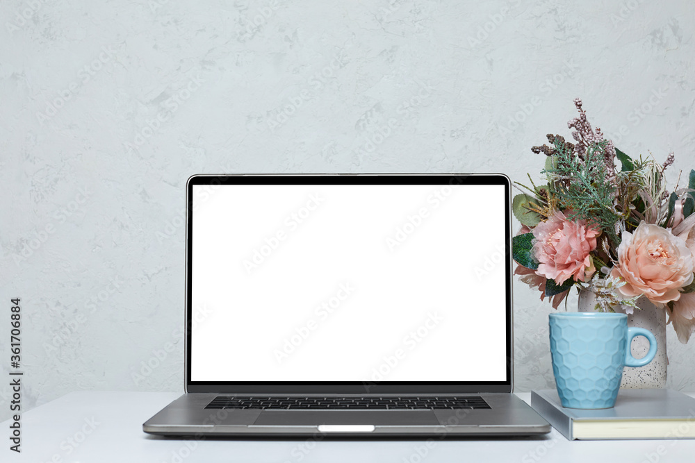 Fototapeta premium Laptop with blank empty screen on white table. Home interior. mockup
