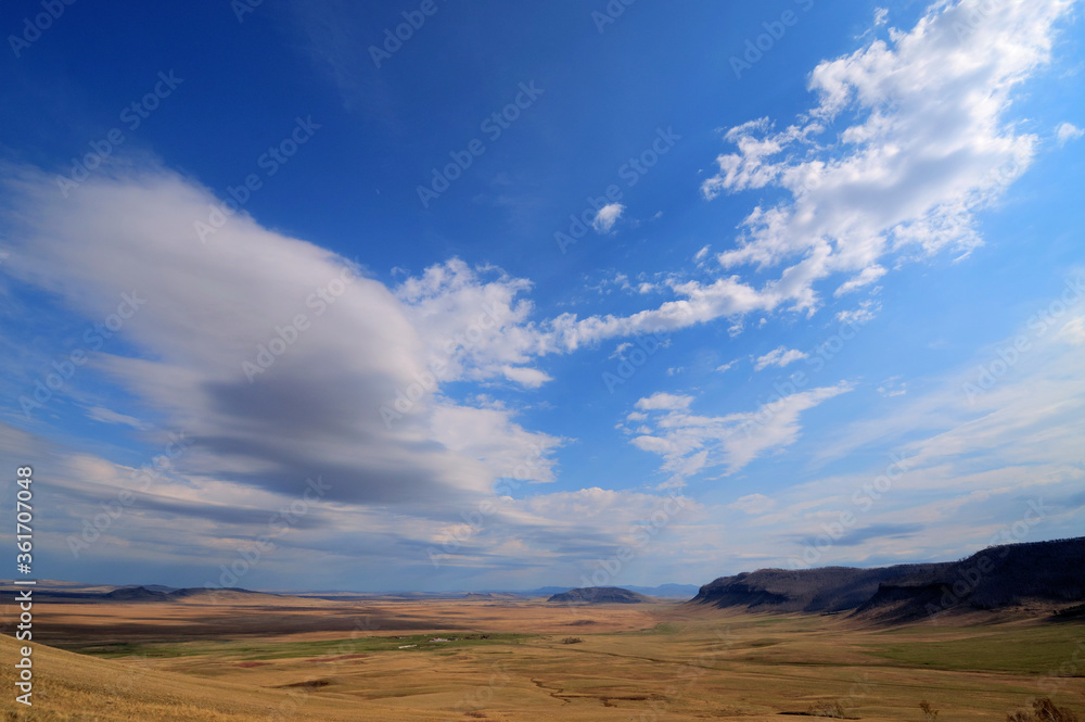 View of the hills with clouds. Mountain-steppe landscape with clouds. South Siberia. The Republic of Khakassia.