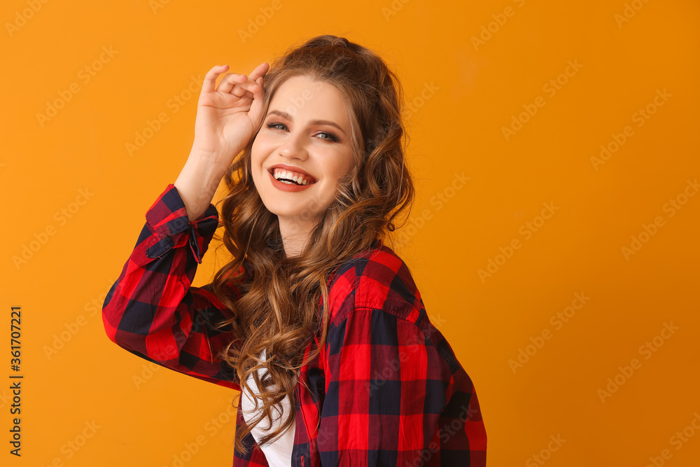 Fototapeta premium Beautiful young woman with stylish hairdo on color background