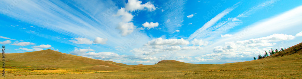 View of the hills. Mountain-steppe landscape with clouds. South Siberia. The Republic of Khakassia. View of the hills. Mountain-steppe landscape with clouds. South Siberia. The Republic of Khakassia.