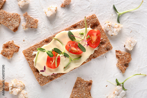 Tableau sur toile Tasty crispbread with tomato, cheese and sprouts on white background