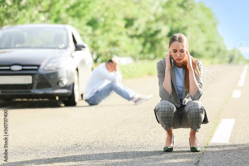 Young woman near broken car...
