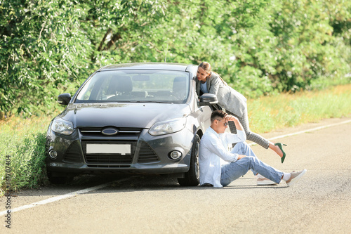 Young couple near broken car on road © Pixel-Shot