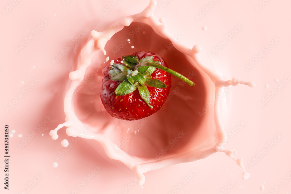 Falling of fresh strawberry into milk Falling of fresh strawberry into milk