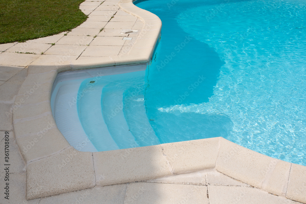 stairs access to water blue swimming pool detail side