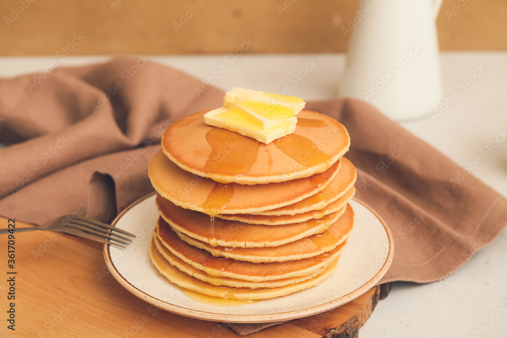 Tasty pancakes with butter and honey on table Tasty pancakes with butter and honey on table