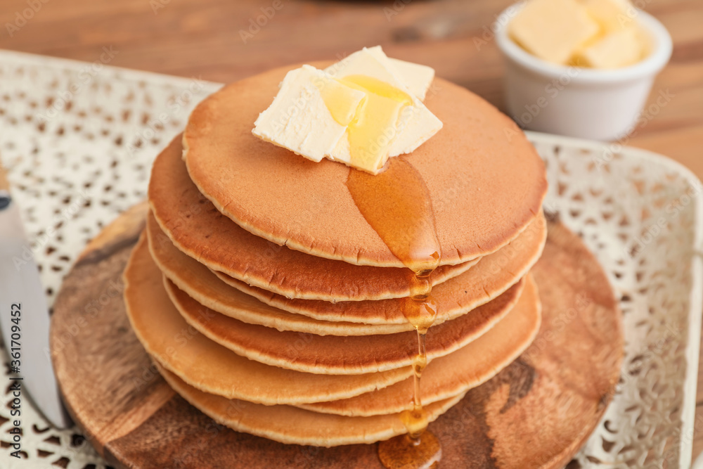 Tasty pancakes with butter and honey on table, closeup Tasty pancakes with butter and honey on table, closeup
