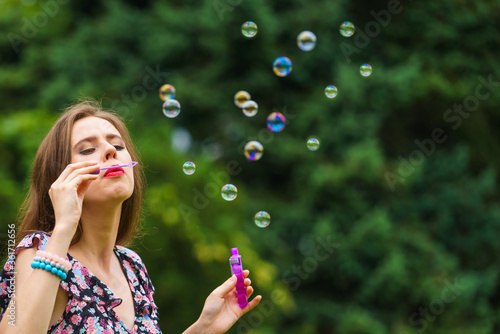 Woman blowing soap bubbles  having fun