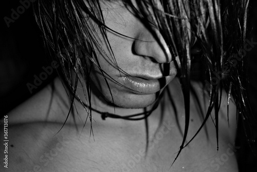 Wet black hair on his face