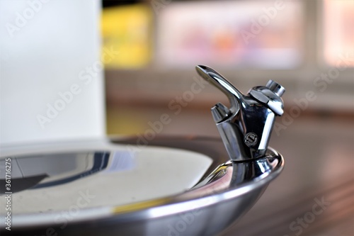 The tap and basin of a drinking fountain or water fountain normally found in airports and train stations