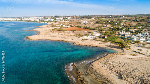 Aerial bird s eye view of Ammos tou Kambouri beach  Ayia Napa  Cavo Greco  Famagusta  Cyprus. Tourist attraction bay  rocky beach with golden sand  sunbeds  sea restaurant in Agia Napa from above.
