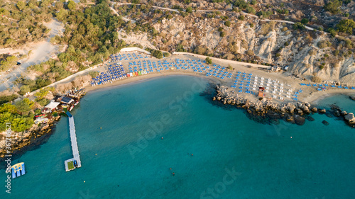 Aerial bird's eye view of Konnos beach in Cavo Greco Protaras, Paralimni, Famagusta, Cyprus. The famous tourist attraction golden sandy Konos bay, yachts, on summer holidays, at sunrise from above photo