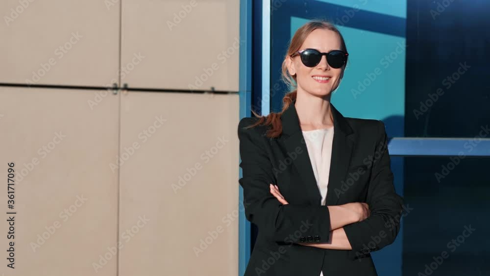 Trendy businesswoman in black jacket posing at modern building. Shot on RED Raven 4k Cinema Camera Trendy businesswoman in black jacket posing at modern building. Shot on RED Raven 4k Cinema Camera