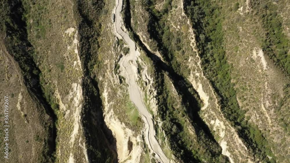 Aerial view - following a sandy track that goes through the mountains
Aerial view - following a sandy track that goes through the mountains