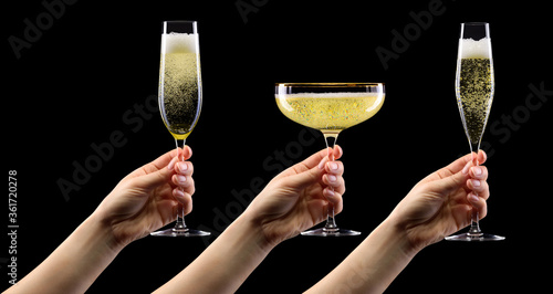 Set of hands holding glass of sparkling champagne isolated on black.