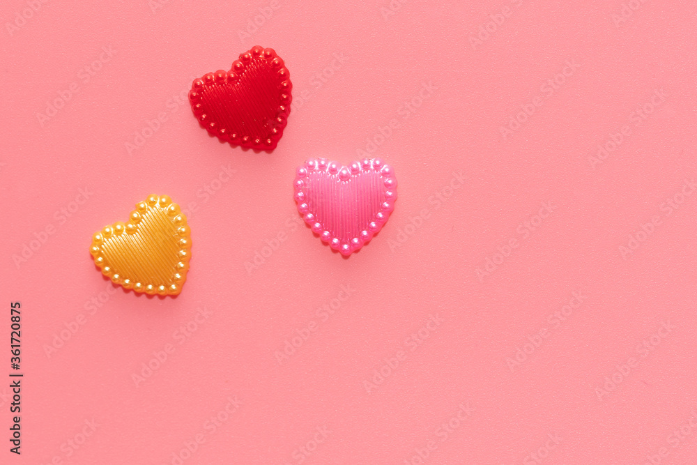Multi-colored hearts on a pink background. Multi-colored hearts on a pink background.