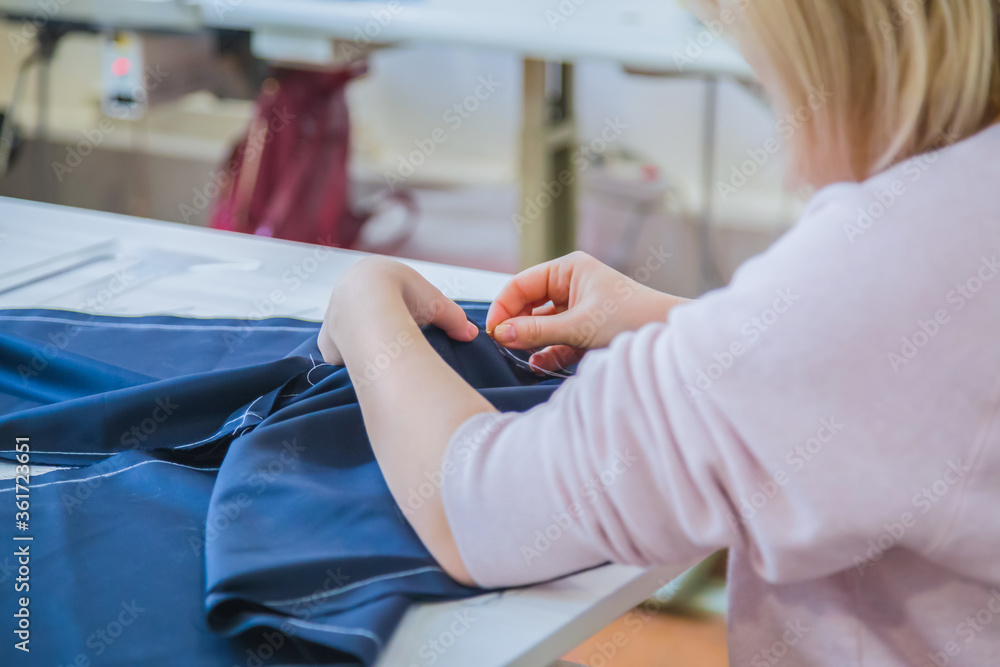Professional tailor, fashion designer working at sewing studio. Preparation process. Fashion, clothing, small business, industry, needlework, manufacturing and tailoring concept