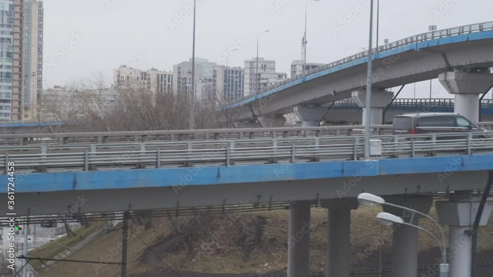 Industrial urban view from train window. Bridges and highways at interchange road junction. Industrial urban view from train window. Bridges and highways at interchange road junction.