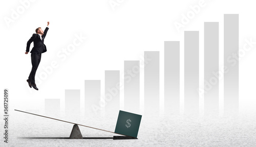 Fotografía Businessman jumping and flying upwards pushing off from a swing lever with inves
