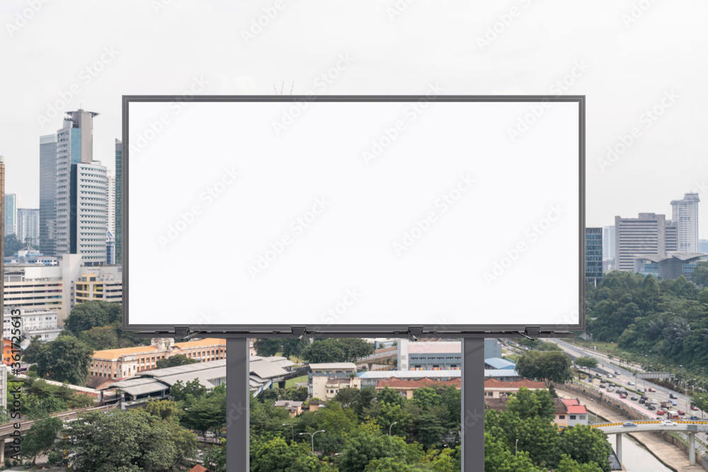 Blank white road billboard with KL cityscape background at day time. Street advertising poster, mock up, 3D rendering. Front view. The concept of marketing communication to promote or sell idea. Blank white road billboard with KL cityscape background at day time. Street advertising poster, mock up, 3D rendering. Front view. The concept of marketing communication to promote or sell idea.