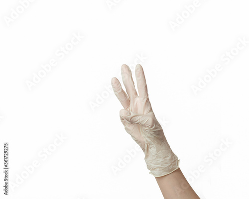 hand of a girl in a white rubber glove on a white background