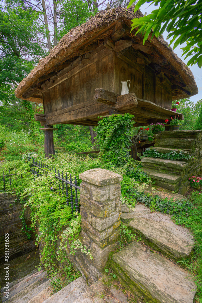 Traditional Horreo raised on wooden pillars with a thatched roof