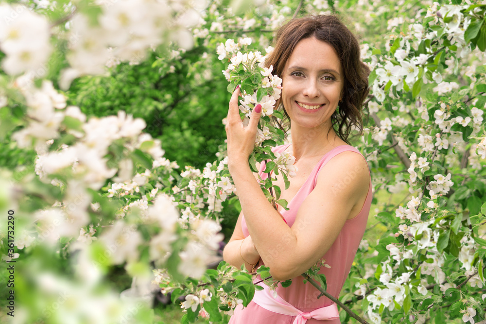 A beautiful woman walks through an Apple orchard. A beautiful woman walks through an Apple orchard.