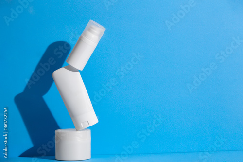 Set of blank white skincare cosmetic products on background with free space for advertising text.