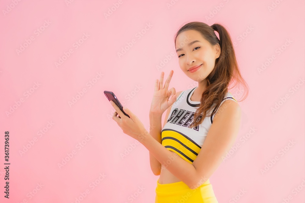 Portrait beautiful young asian woman cheerleader with smart mobile phone Portrait beautiful young asian woman cheerleader with smart mobile phone