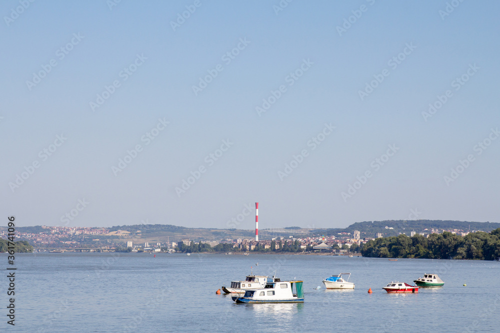 Zemun Quay (Zemunski Kej) in Belgrade, Serbia, on the Danube river, seen in summer. Boats can be seen in front, and Belgrade center in background