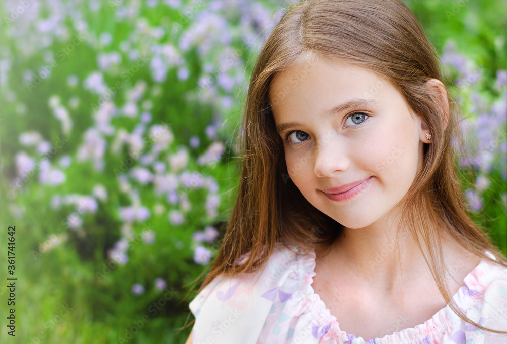 Portrait of adorable smiling little girl child in summer day. Happy preteen in the park Portrait of adorable smiling little girl child in summer day. Happy preteen in the park