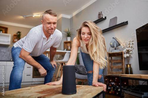 Man And Woman Looking At Ai Speaker During Party
